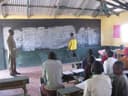 A teacher and pupils in a Kenyan primary school classroom