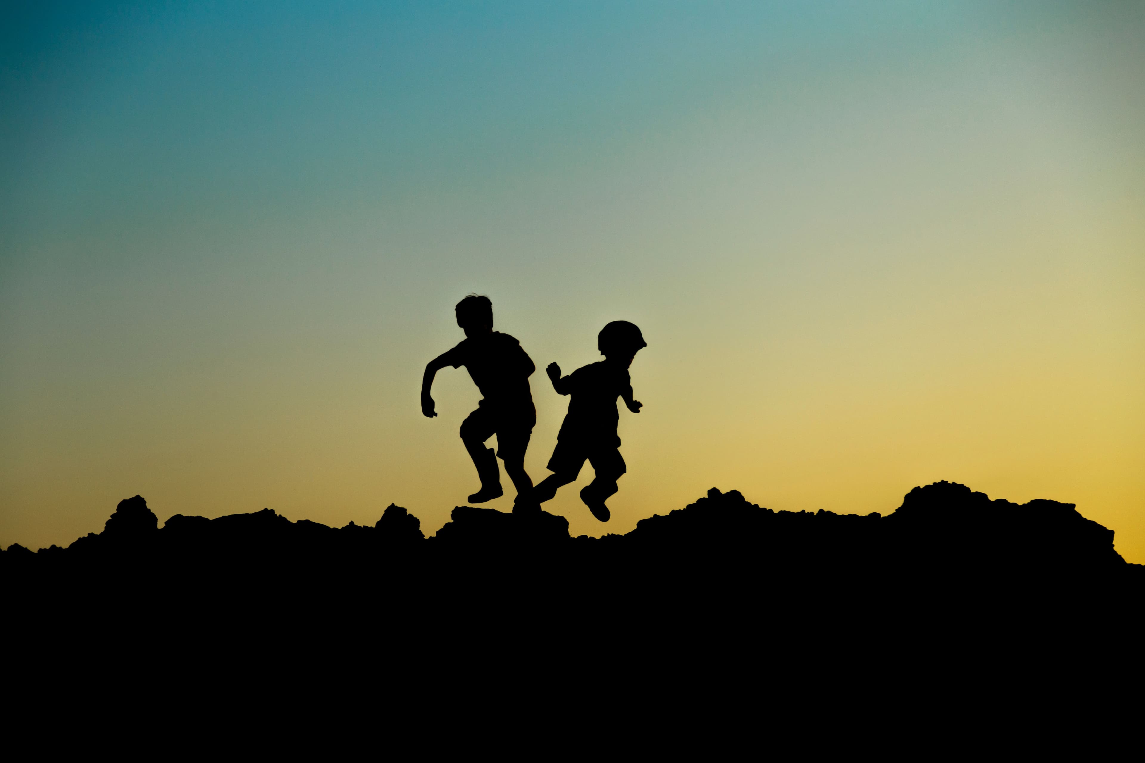 Children running joyfully at sunset, looking ahead to what's next